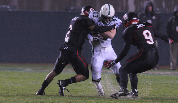 Tight end and linebacker Michael Cullen (11) fights off two Centennial defenders in the CIF division I state chapionship game.