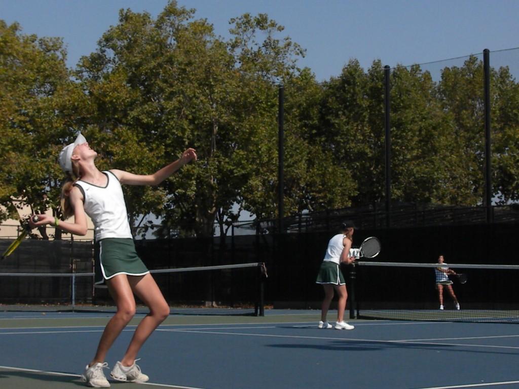 Hollie Kool (14) prepares for a serve in a game with doubles partner Katy Abbott (13). They won their match 6-2.