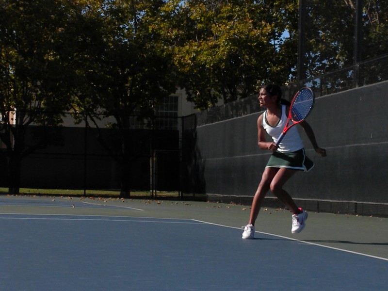 Budhiraja runs for a return in the first set. As the No. 1 single, she plays in every meet. Photo by Hilda Huang
