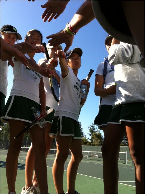 Team captain Amy Ke (12) leads the girls in their pre-meet cheer. P-A-L-O-A-L-T-O wasnt quite enough to edge out Lynbrook; Paly lost 3-4.