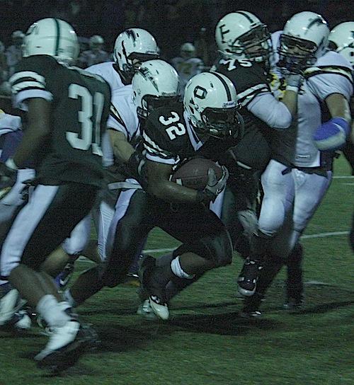 Dre Hill (12) powers through the middle for a large gain. Hill had one touchdown for the night. 