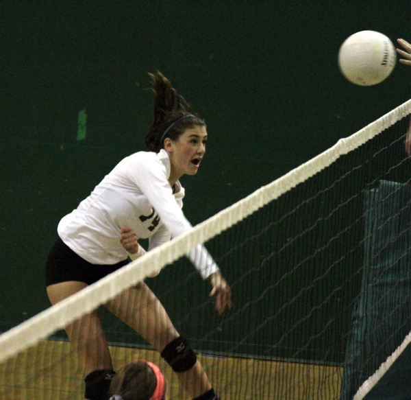 Becca Raffel (14) completes a kill in the fourth set of the match. 
