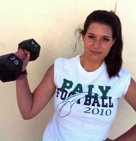 Michelle Friedlander (13) shows off her strength by lifting a 25 pound weight 