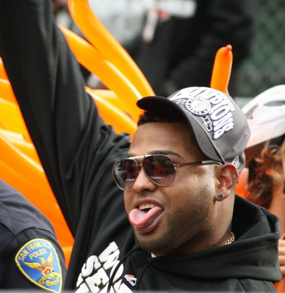 Most valuable player, Pablo Sandoval cheers as he rides down Market Street in a convertible during the World Series parade. 