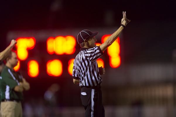 Local Palo Alto referee gives a call in a Paly football home game