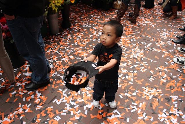 A young Giants fan catches the magic in his hat along Market Street during the Giants parade. More than one million fans lined the streets of San Francisco to cheer on the World Series champions on Halloween.