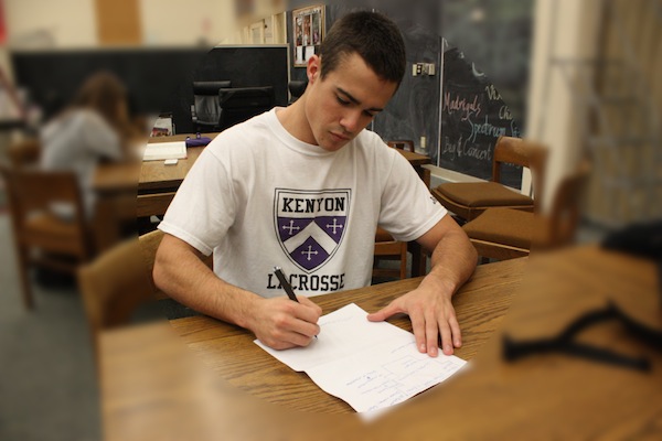 Walker Mess (13) dressed in his Kenyon attire  practices his signature 