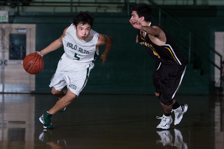 Aldis Petriceks (13) flies by a Mountain View defender. Petriceks and the Paly boys’ basketball team defeated the Spartans 41-30 on Quad Night. 