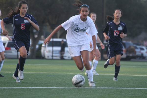 Alyssa Maharaj (14) dribbles past Lynbrook defenders before taking a shot. The Vikings went on to win 4-0.
