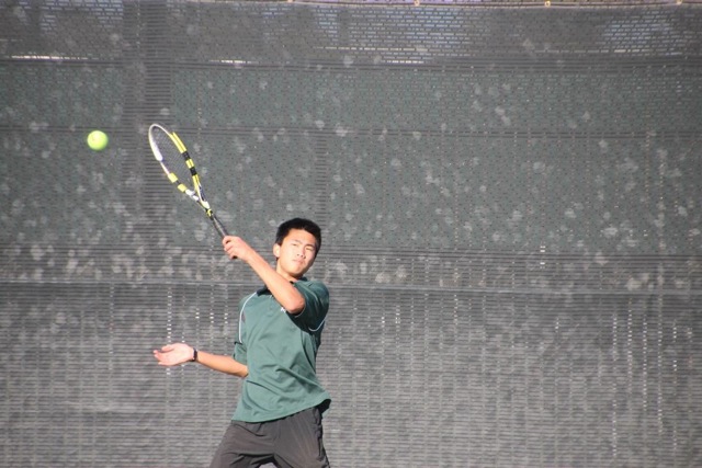 Number one singles player Austin Leung (14) hits a forehand. 