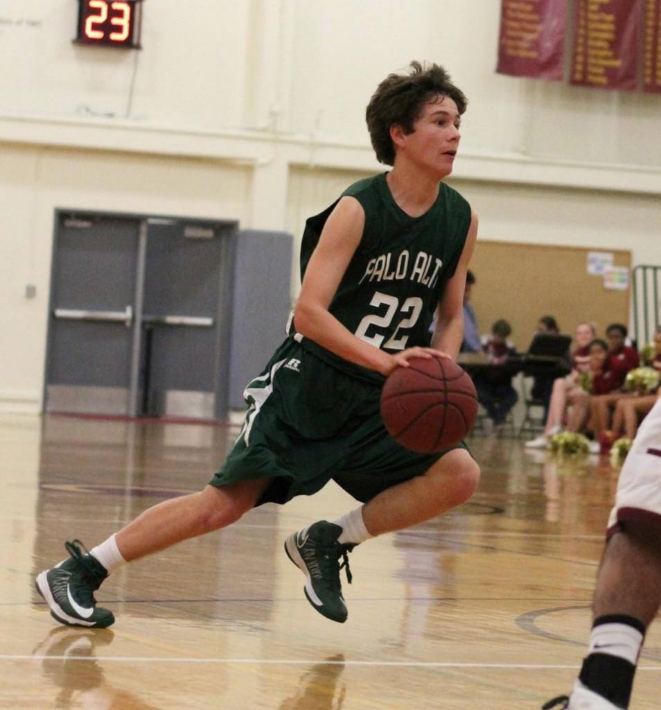 Kevin Mullin (‘15) dribbles the ball towards the basket. Mullin was pulled up to the varsity basketball team last year by Coach Adam Sax. 