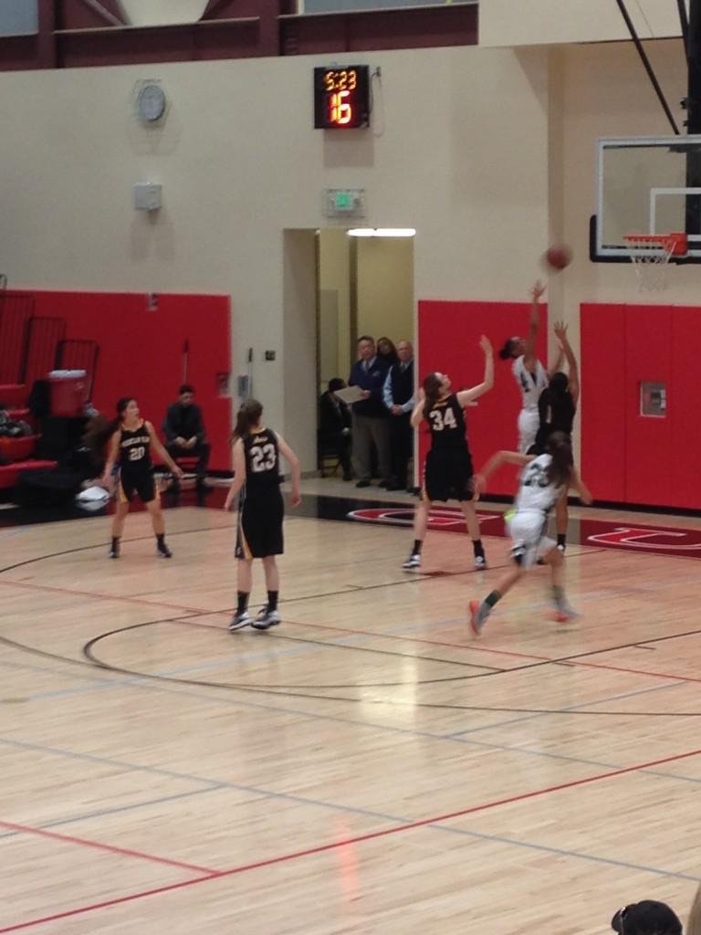 Alexis Harris goes up for a shot against two Mountain View defenders. Paly would go on to win 57-54.