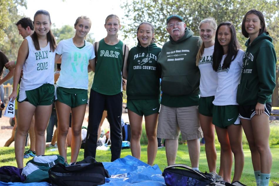 Runners on the girls’ varsity cross country team pose with coach Paul Jones. There are 52 athletes on the roster and many of them have a passion for running. 