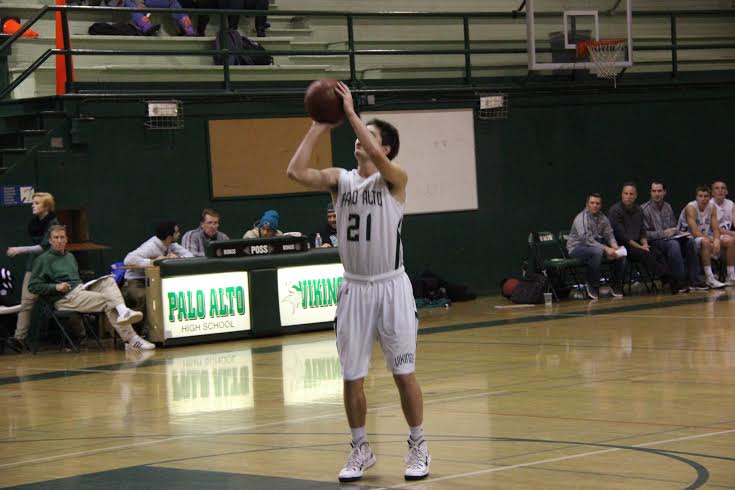 Kevin Mullin (15) attempts a three-pointer. The Vikings finished off the game with a score of 72-61.