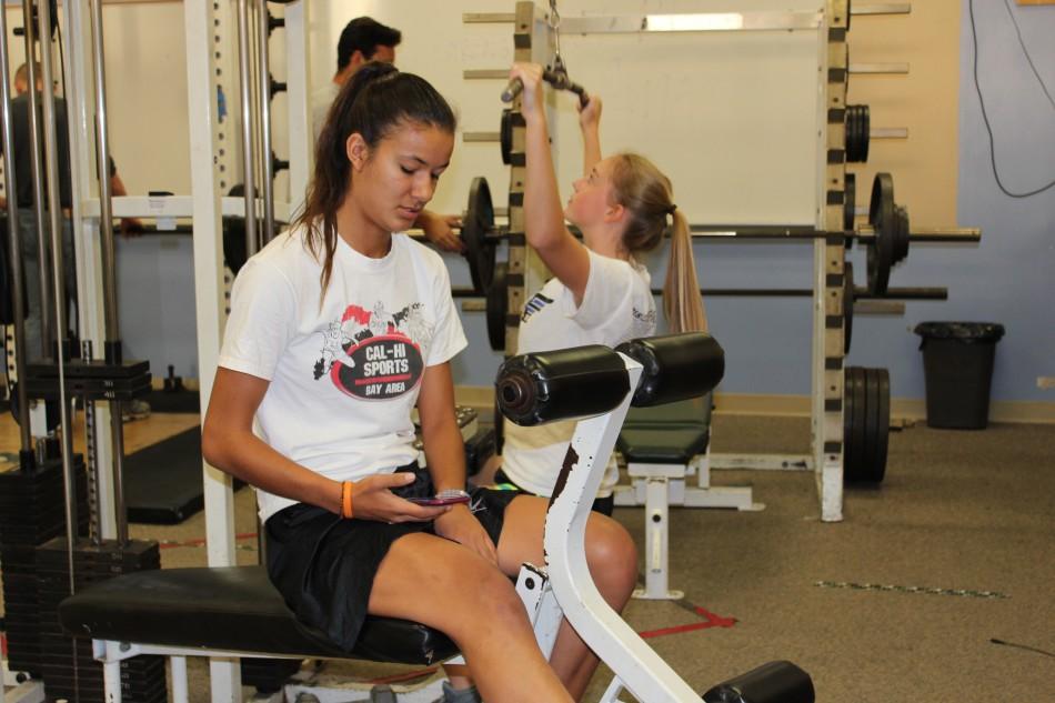 Courtney Lovely (16) works out in the Paly weight room with the rest of the girls basketball team