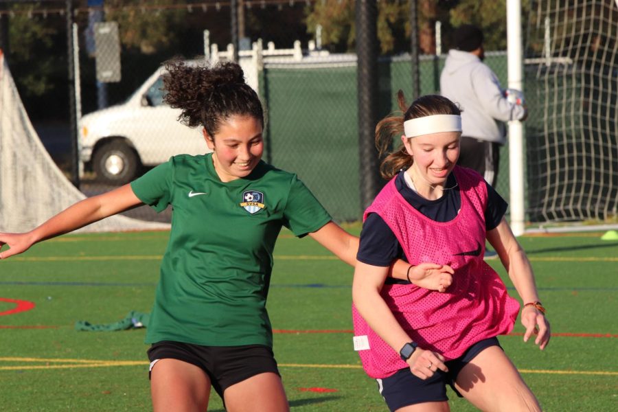 Miya Whiteley (left) and Kiana Feldis (right) jostle over the ball in one of the teams morning scrimmages. Photo by Grace Gormley.