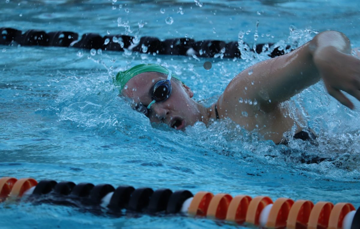 Junior Katie Spitzer competes in the 400 freestyle relay. Photo by Grace Gormley. 