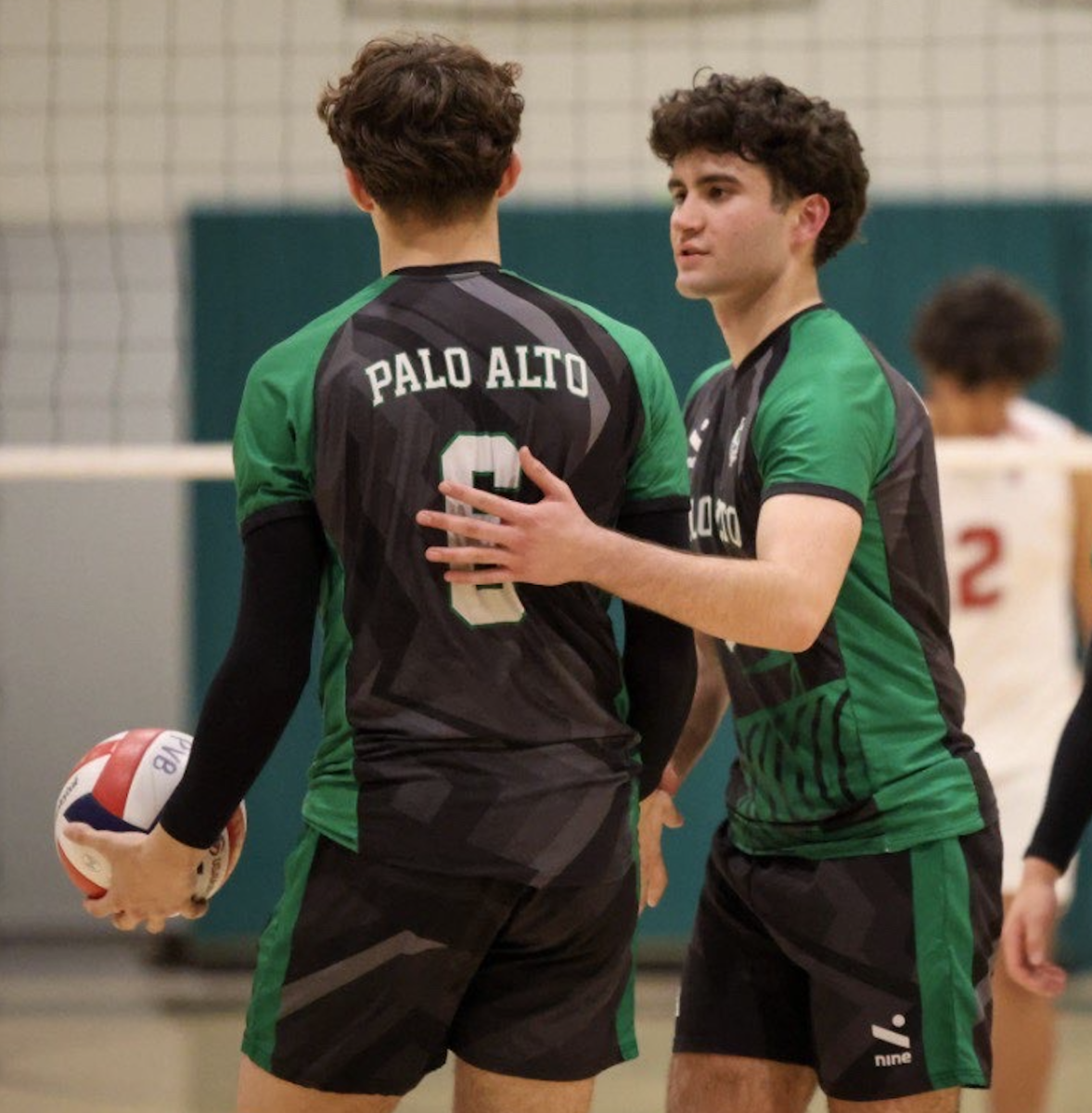 Sophomore Diego Hakeman congratulates teammate after a perfect serve. 